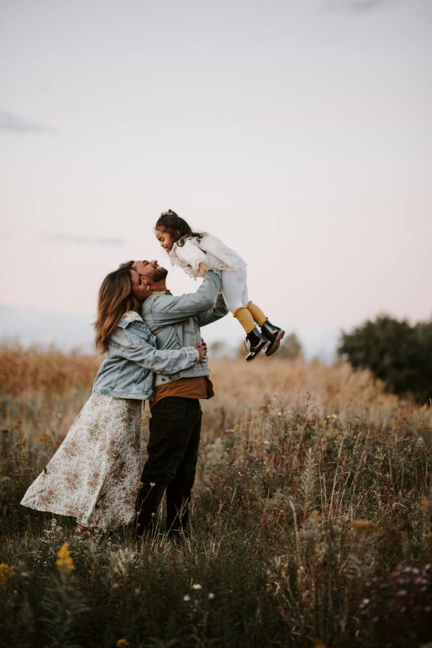 Parents lifting their child joyfully